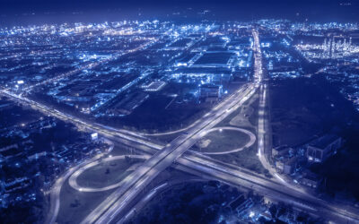 Spaghetti junction within lit up cityscape with blue filter